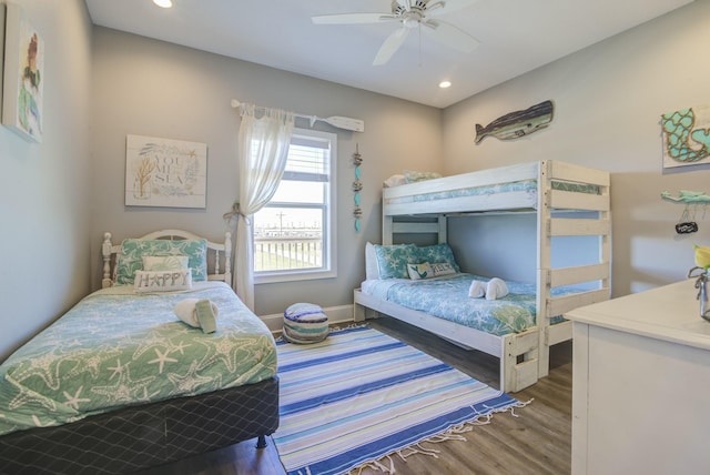 bedroom featuring ceiling fan, baseboards, wood finished floors, and recessed lighting