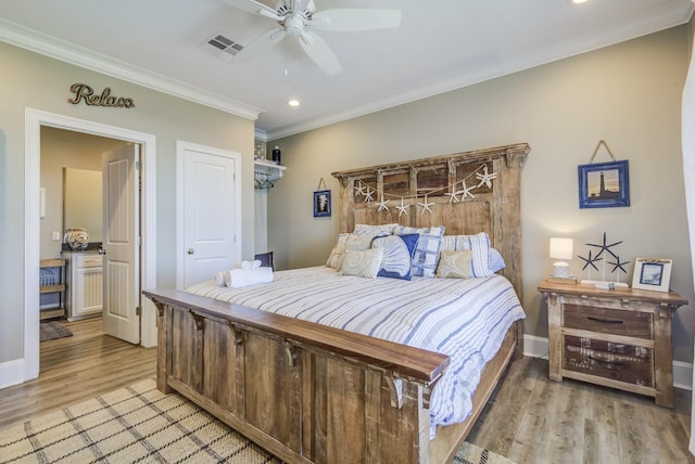 bedroom featuring recessed lighting, visible vents, crown molding, and light wood finished floors