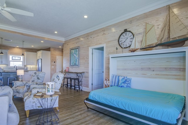 bedroom featuring recessed lighting, ornamental molding, freestanding refrigerator, wood finished floors, and baseboards