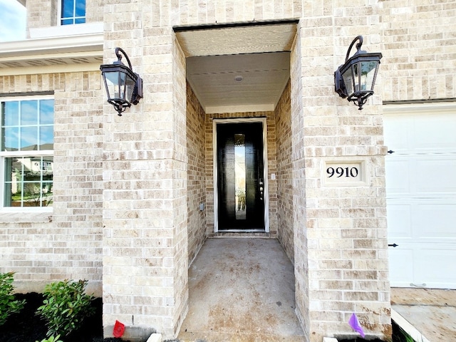 doorway to property with a garage