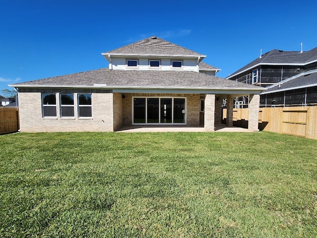 rear view of property featuring a yard and a patio