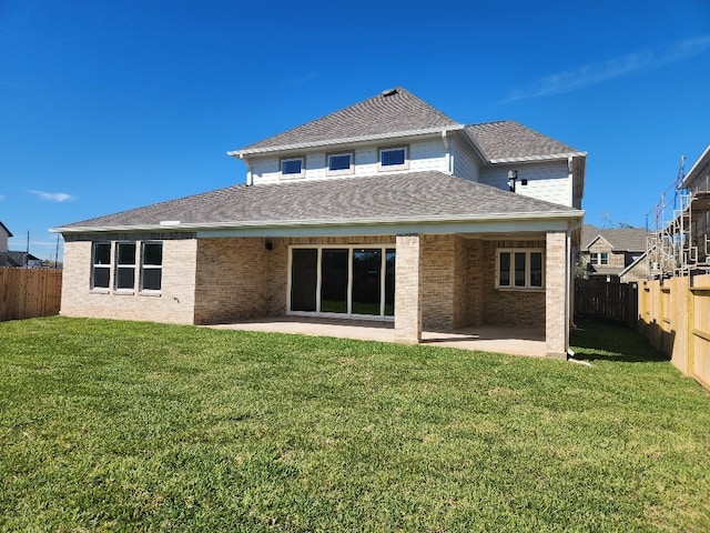 back of property featuring a patio area and a yard