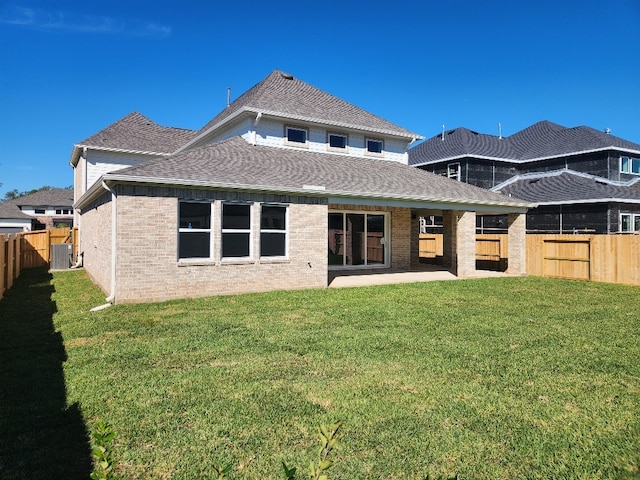 rear view of house with a patio area, a yard, and central air condition unit