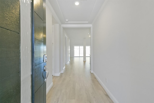 hallway with crown molding and light hardwood / wood-style floors