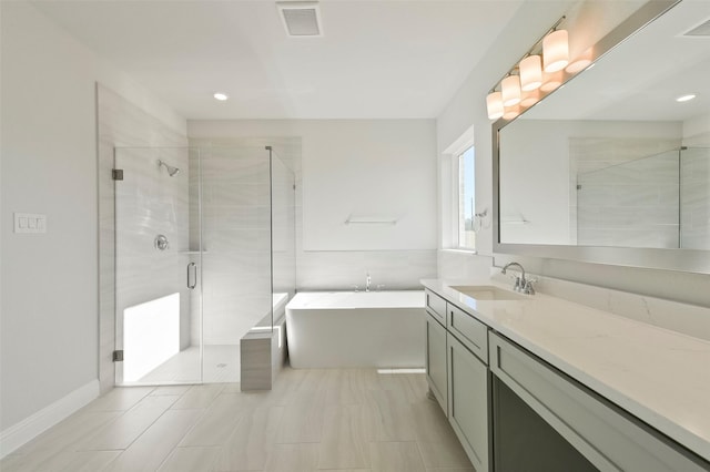 bathroom featuring tile patterned floors, vanity, and separate shower and tub