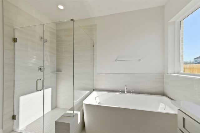 bathroom with shower with separate bathtub