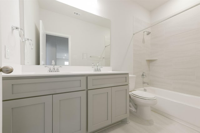 full bathroom with vanity, toilet, and tiled shower / bath combo