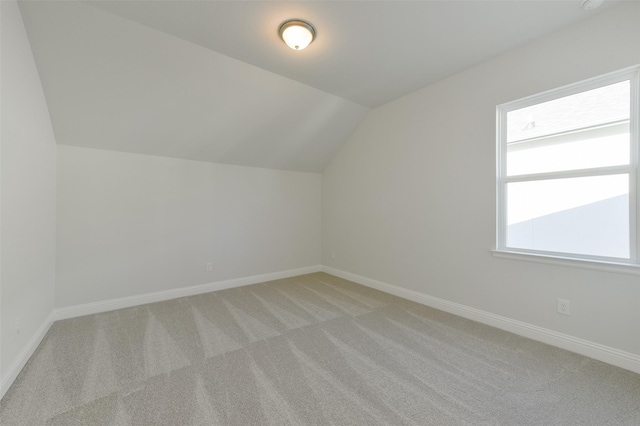 bonus room featuring light colored carpet and lofted ceiling