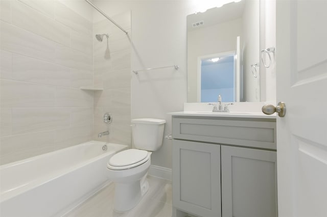 full bathroom with tiled shower / bath, vanity, and toilet