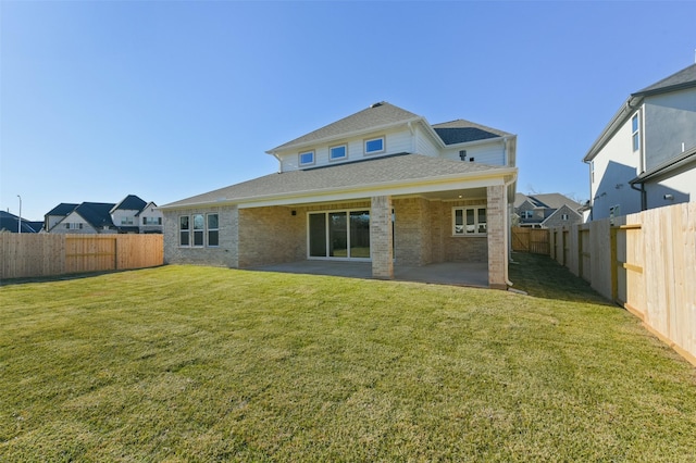 back of house featuring a lawn and a patio