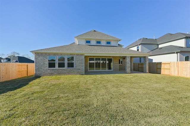 rear view of property with a patio and a lawn