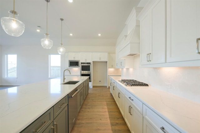 9931 Hunters Run Dr, Missouri City, TX 77459 - kitchen featuring hanging light fixtures, appliances with stainless steel finishes, sink, and white cabinets