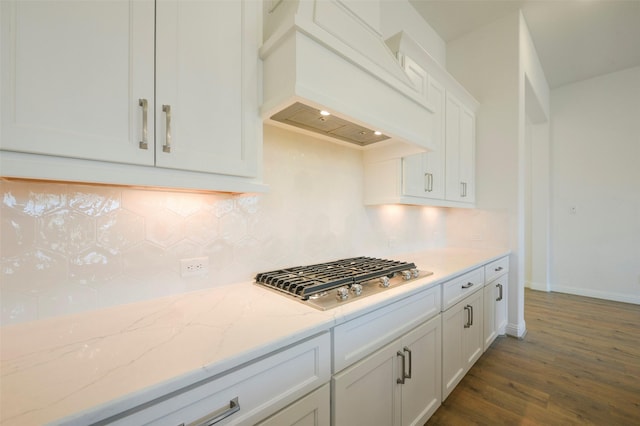 9931 Hunters Run Dr, Missouri City, TX 77459 - kitchen featuring backsplash, light stone counters, stainless steel gas cooktop, white cabinets, and custom exhaust hood