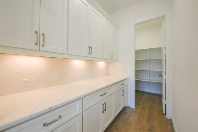 9931 Hunters Run Dr, Missouri City, TX 77459 - kitchen with tasteful backsplash, light stone countertops, dark hardwood / wood-style floors, and white cabinets