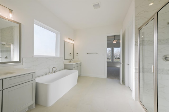 9931 Hunters Run Dr, Missouri City, TX 77459 - bathroom with plus walk in shower, tile walls, vanity, and ceiling fan