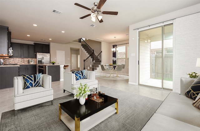 living room featuring ceiling fan and light tile patterned floors