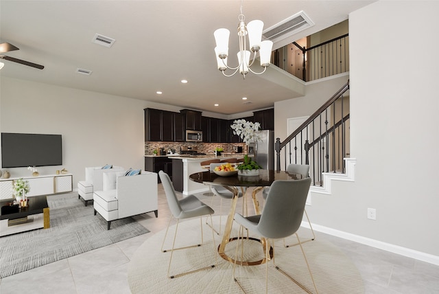 dining area featuring light tile patterned flooring and a chandelier