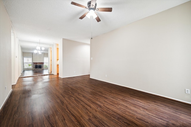 unfurnished living room with a textured ceiling, wood-type flooring, and ceiling fan with notable chandelier