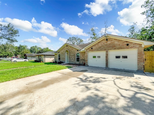 ranch-style home with a garage and a front lawn