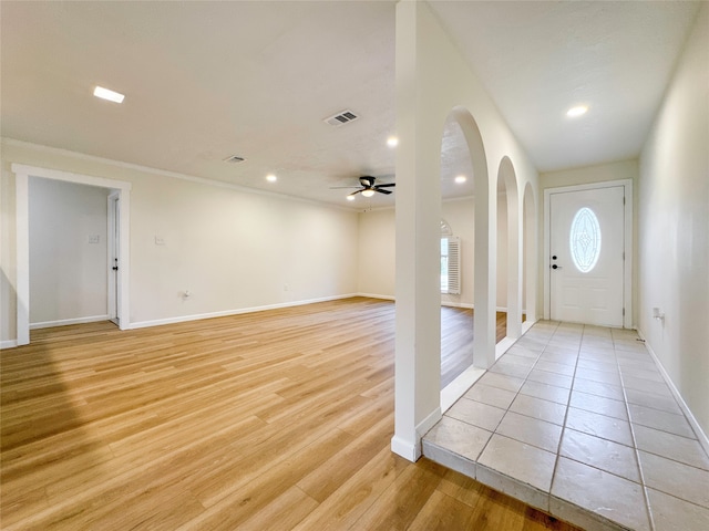 foyer with ceiling fan and light wood-type flooring