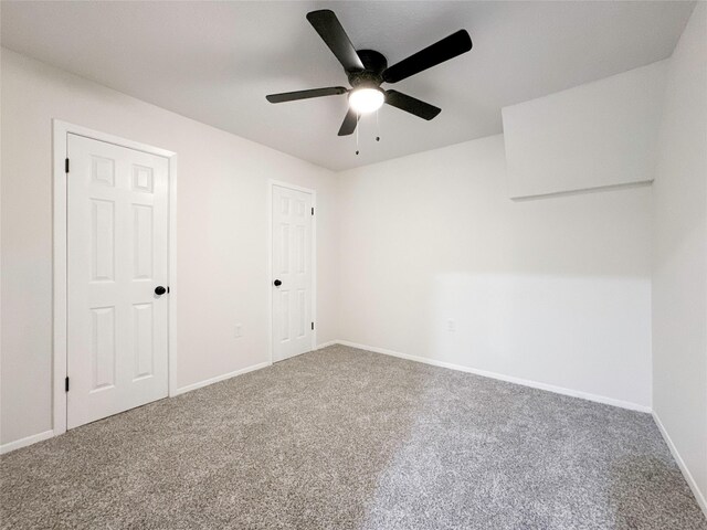 empty room with carpet flooring and ceiling fan