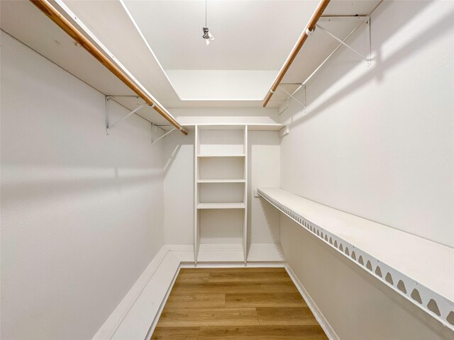 spacious closet featuring hardwood / wood-style flooring