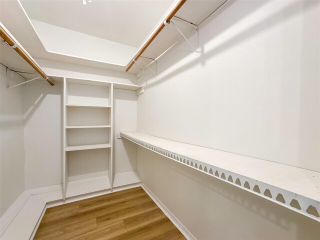 spacious closet featuring hardwood / wood-style flooring