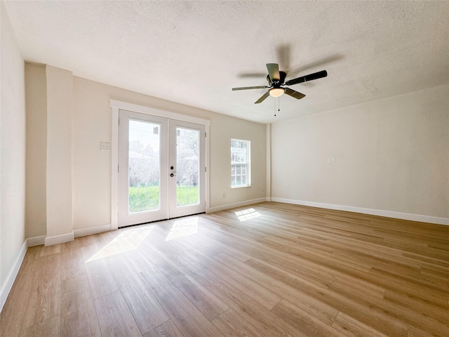 spare room with french doors, a textured ceiling, ceiling fan, and light hardwood / wood-style floors