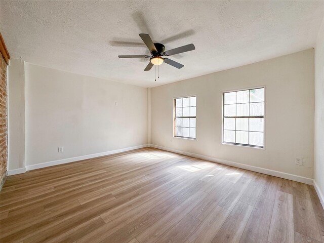 empty room featuring a textured ceiling, ceiling fan, and light hardwood / wood-style floors