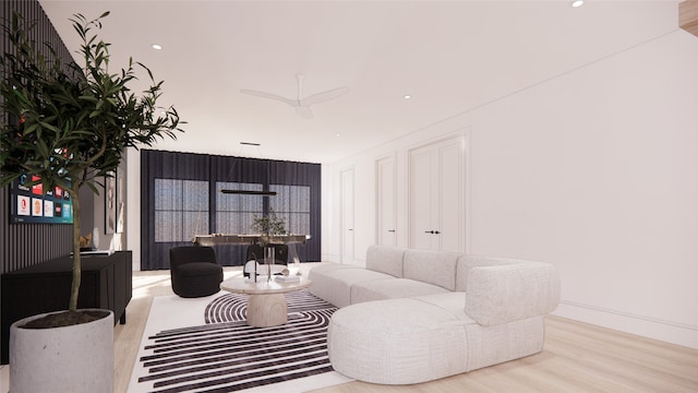 living room with light wood-type flooring and ceiling fan