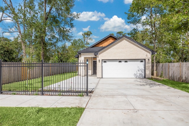 view of front of property with a front yard and a garage