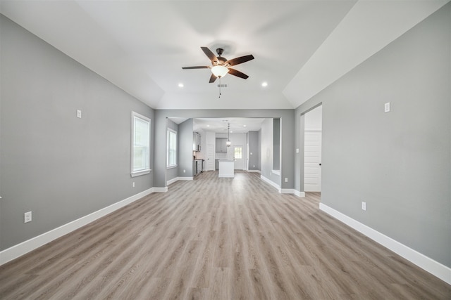 unfurnished living room featuring light hardwood / wood-style flooring and ceiling fan