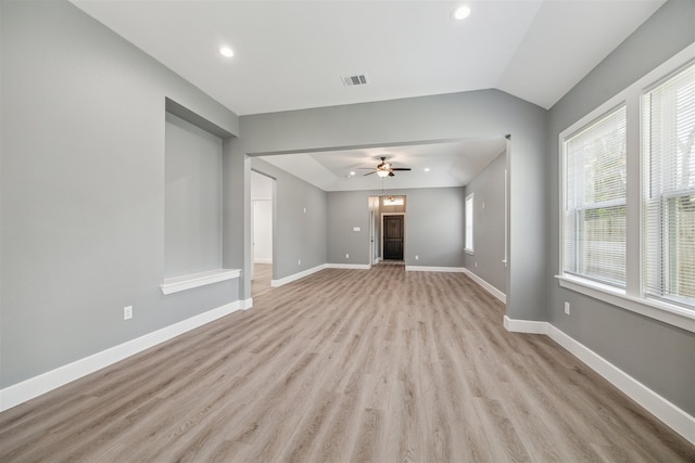 unfurnished living room with ceiling fan, light wood-type flooring, and lofted ceiling