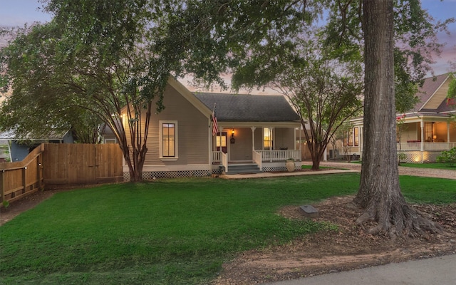 view of front of house with a porch and a yard