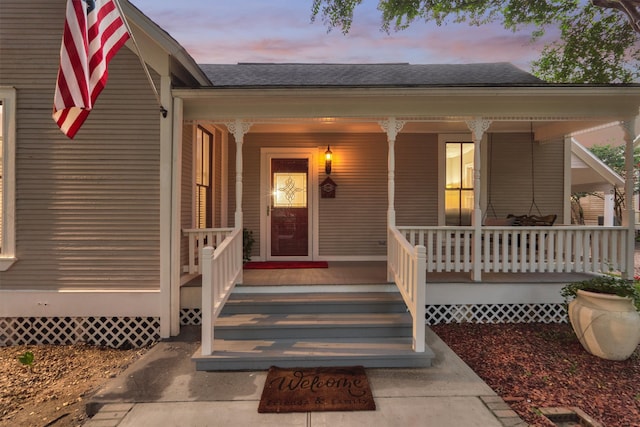 exterior entry at dusk with a porch