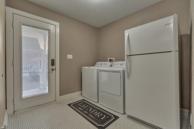 laundry room featuring washer and dryer and a textured ceiling