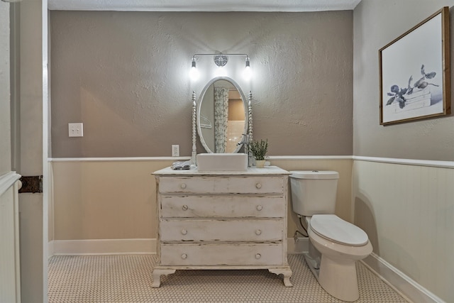 bathroom with vanity, toilet, and tile patterned flooring