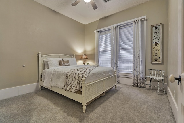 carpeted bedroom with a textured ceiling and ceiling fan