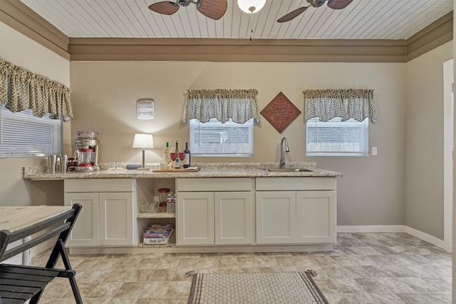 kitchen featuring sink, ceiling fan, a wealth of natural light, and light tile patterned floors