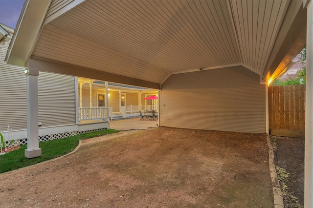 patio terrace at dusk featuring covered porch