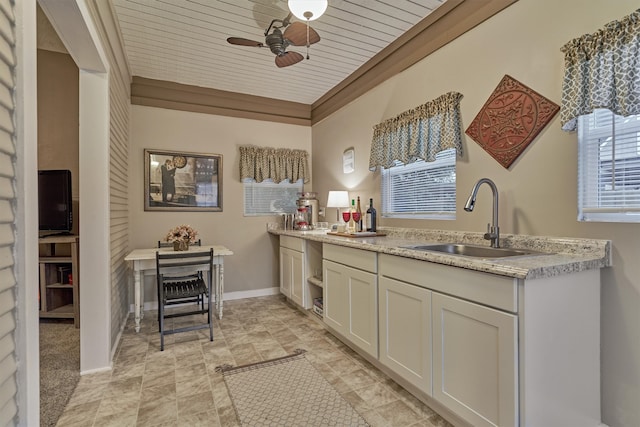 kitchen featuring sink, white cabinets, light tile patterned floors, and ceiling fan