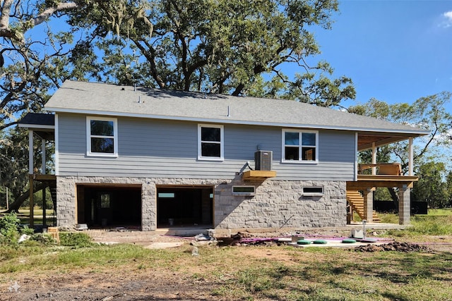 back of property with a balcony and a garage