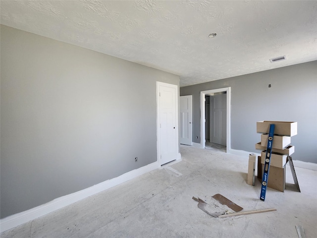 empty room featuring a textured ceiling