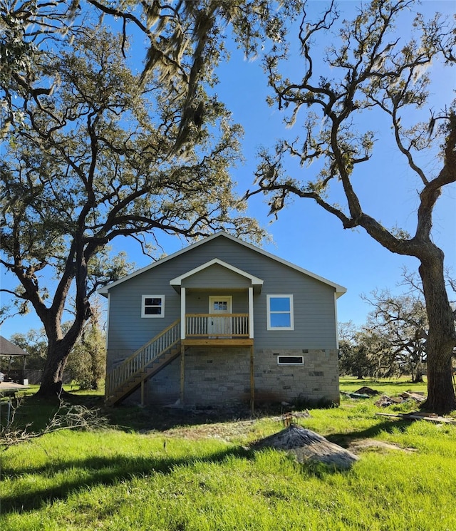 view of property exterior featuring stairs and a yard