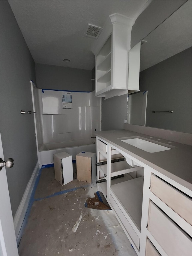 bathroom featuring shower / tub combination, vanity, and visible vents