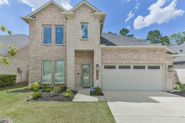 view of front of house with a garage and a front yard