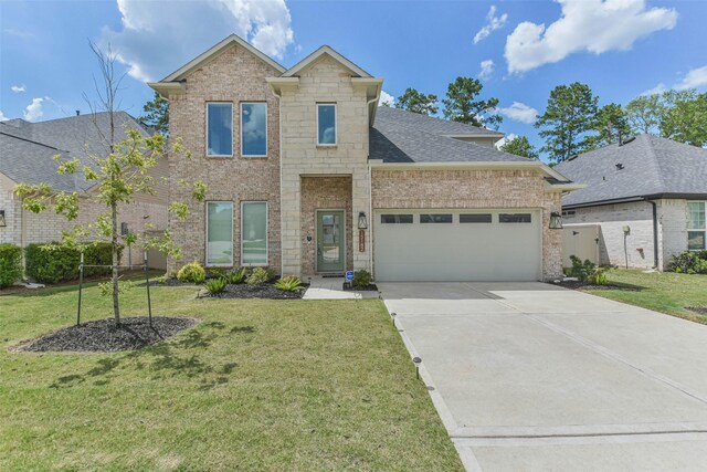 view of front of house featuring a garage and a front yard