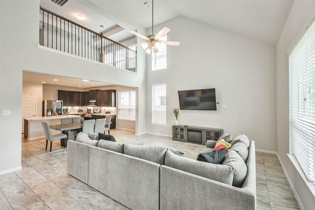 tiled living room with high vaulted ceiling, beamed ceiling, and ceiling fan