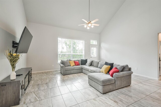 tiled living room featuring high vaulted ceiling and ceiling fan