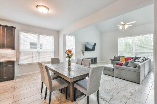 dining room with lofted ceiling with beams, ceiling fan, and light tile patterned floors